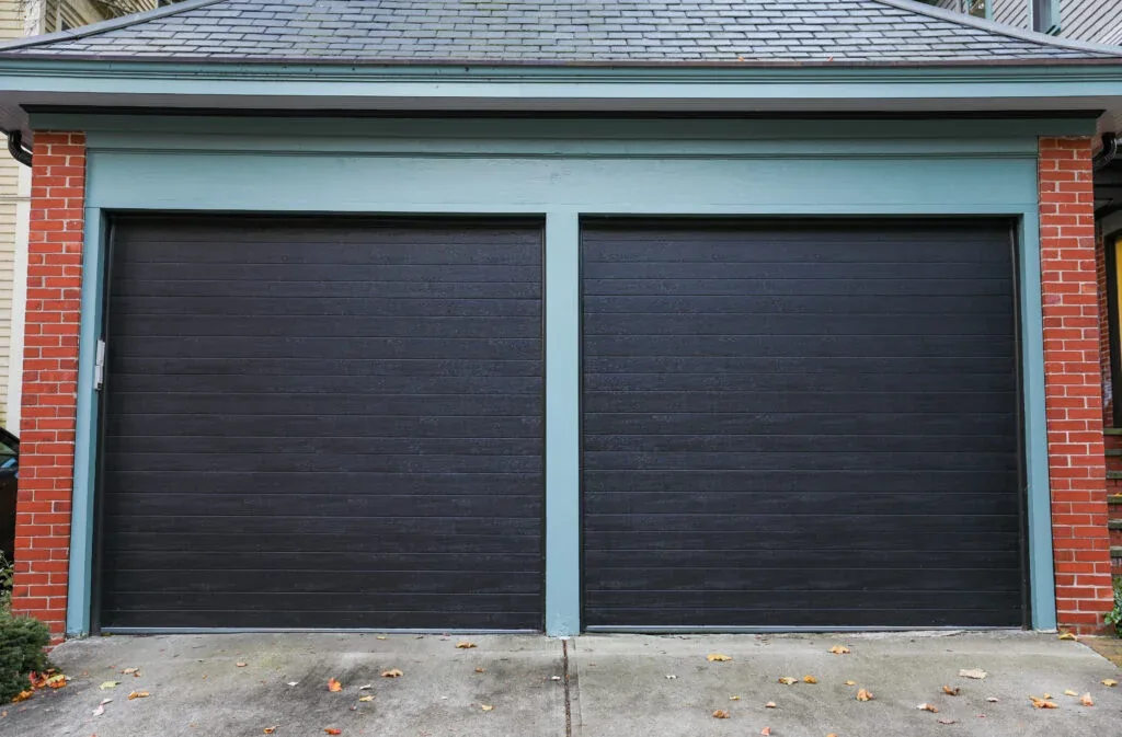 New garage door installed on a brick home, representative of the DFW neighborhoods Tyson Garage Door serves